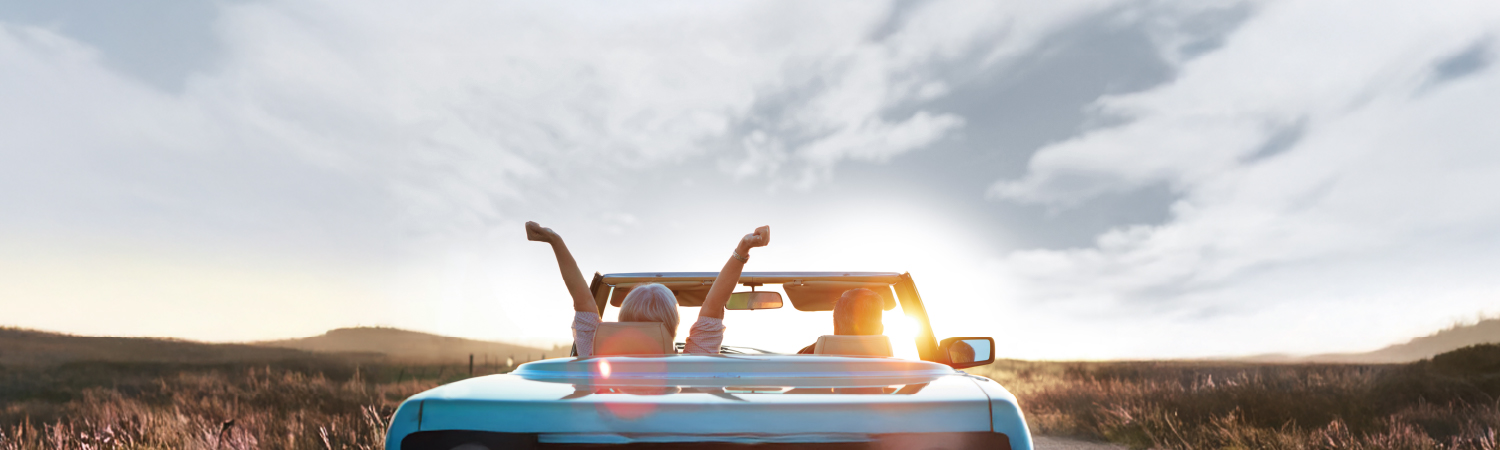 Couple riding in their car at sunset
